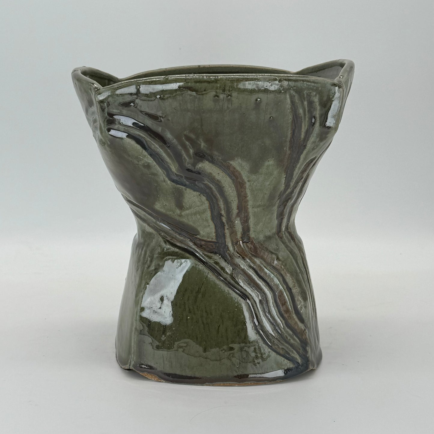 Pedestal bowl Inspired by the sediments featured in the rocks that cover the North Fork of Long Island, this chalice shaped serving bowl features black iron oxide to accentuate their beauty. Organic and hefty, this is a stand out piece for any table.
