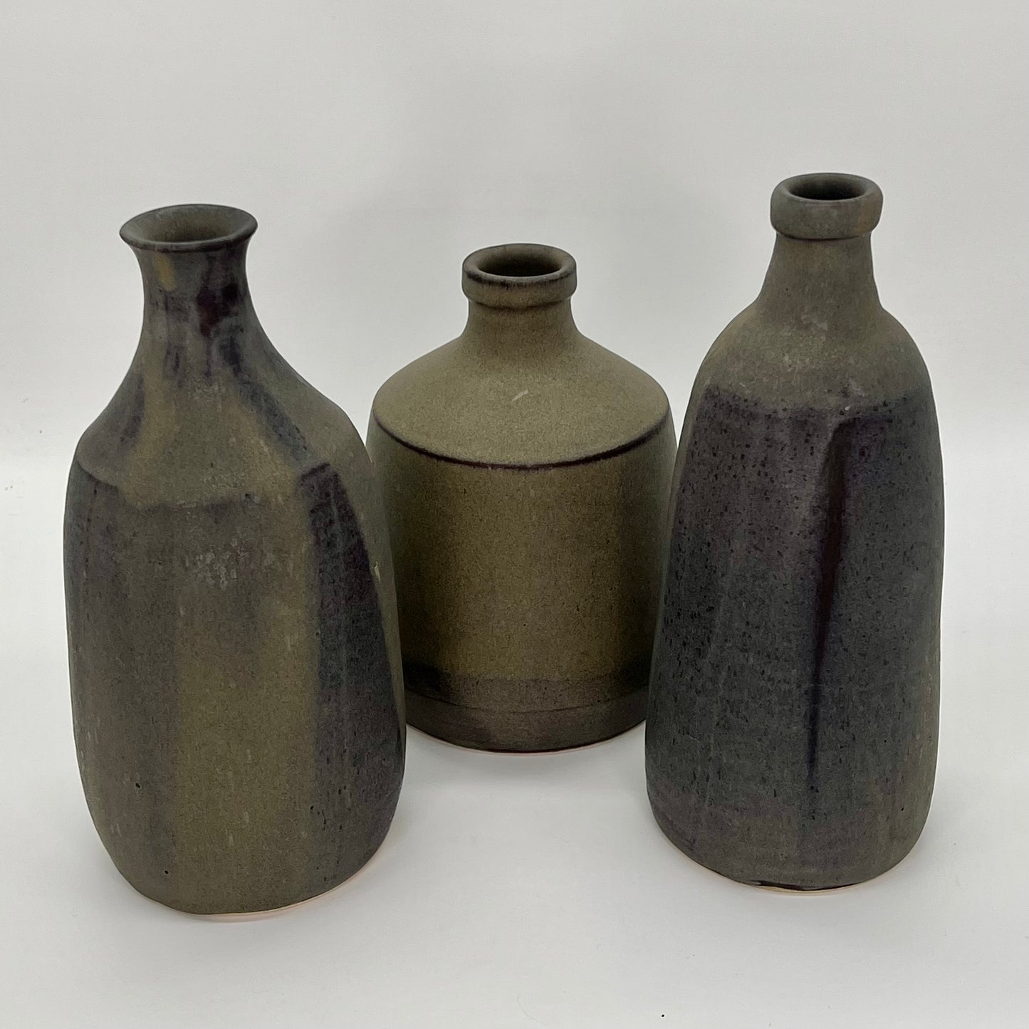 Handsome decorative bottle. Finished in pour-over pussywillow (brown/gray matte glaze). Image of three vases of different shapes and sizes.