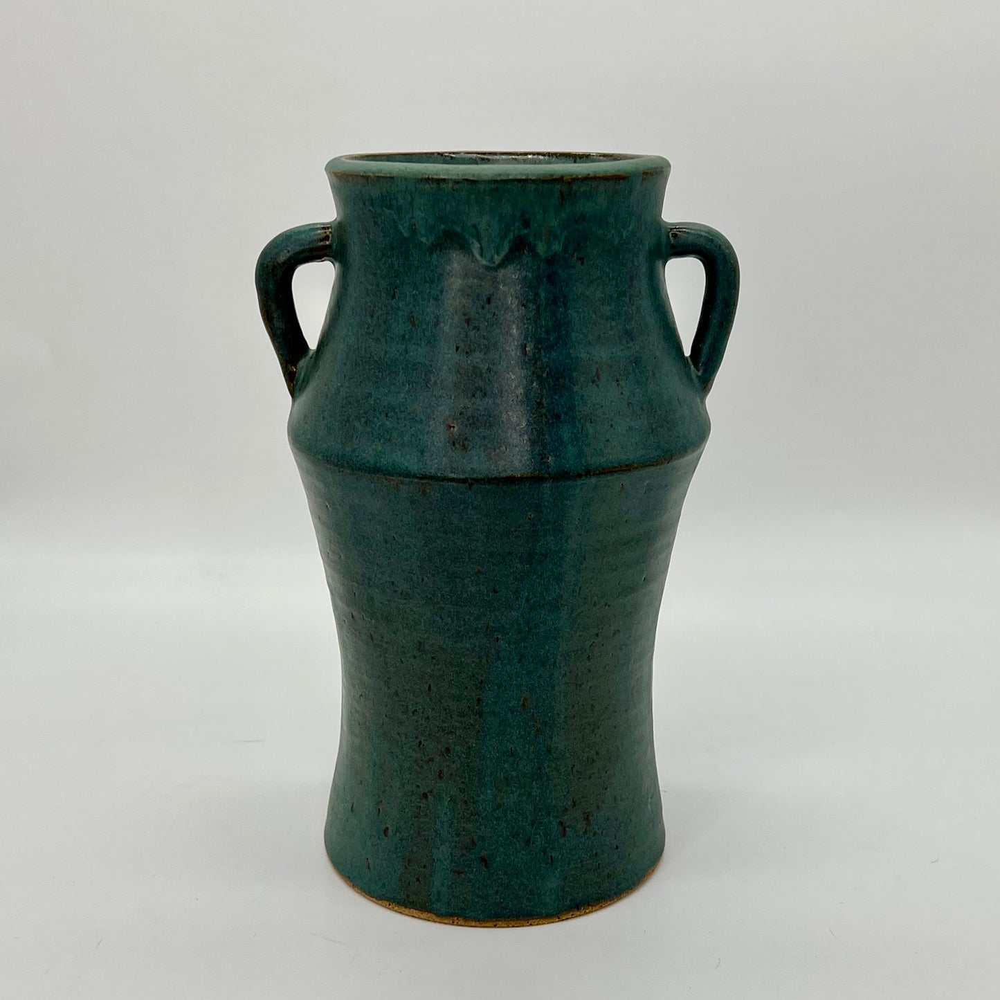 Hand-made, tall vase built by joining two pieces off the wheel. Satin, blue spruce finish.