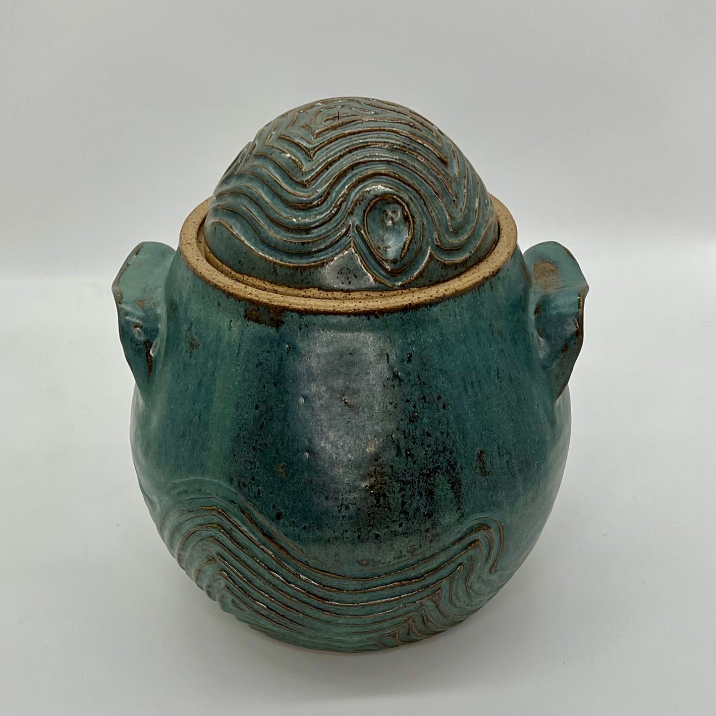 Sedimentary Pickle Jar with hand-built handles and carvings that echo the sediments found on many rocks of the North Fork. Finished in a satin blue spruce glaze.