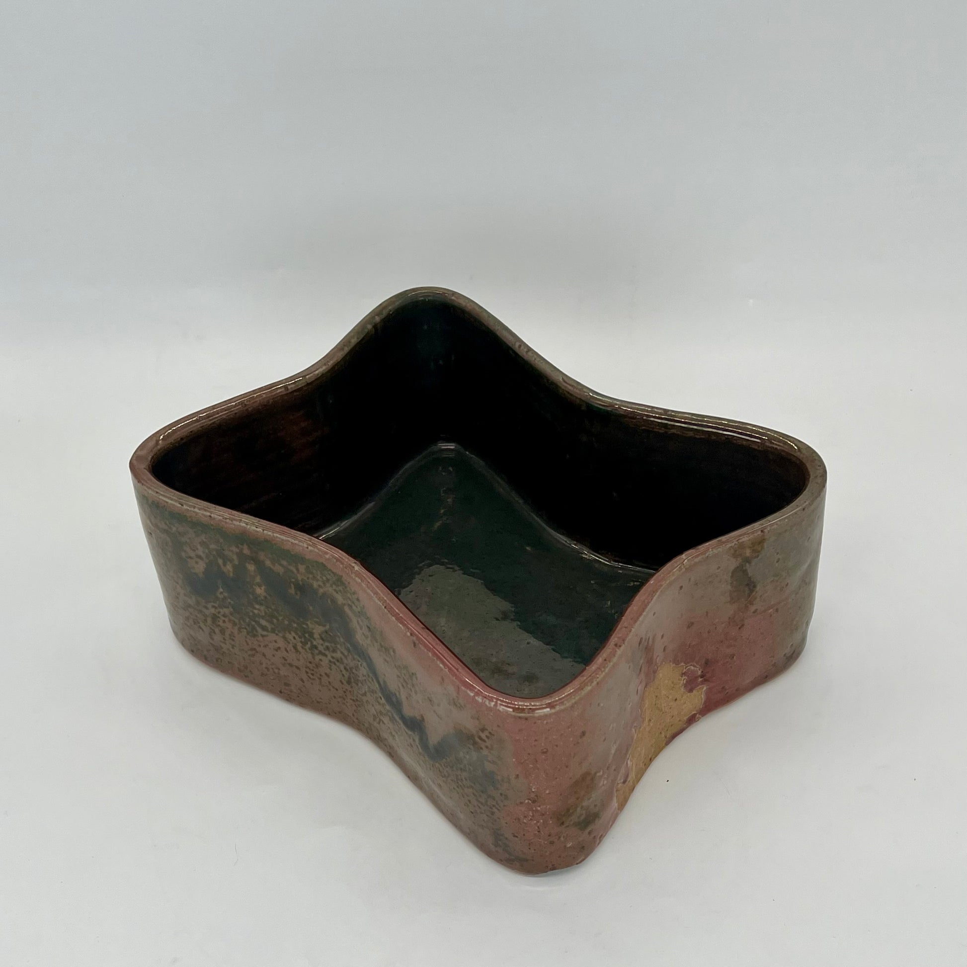 Butterfly-shaped planter. Finished in orbit glaze that is iridescent with coppers, browns, and blues.