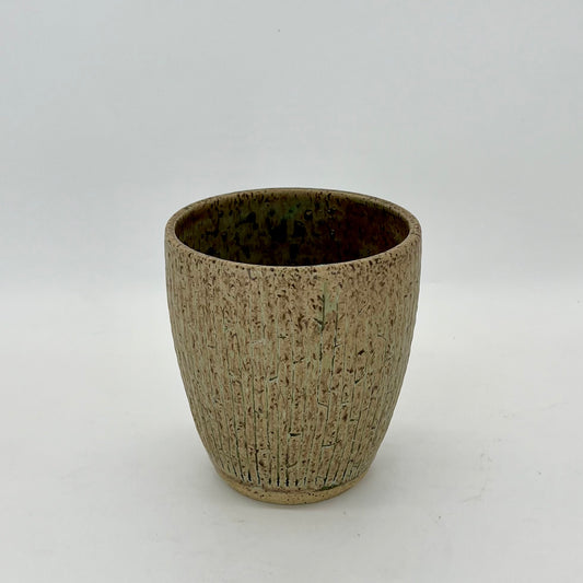 Vase with seaweed glaze and carved pieces creating crevices within the vessel.  Pattern evokes bamboo.
