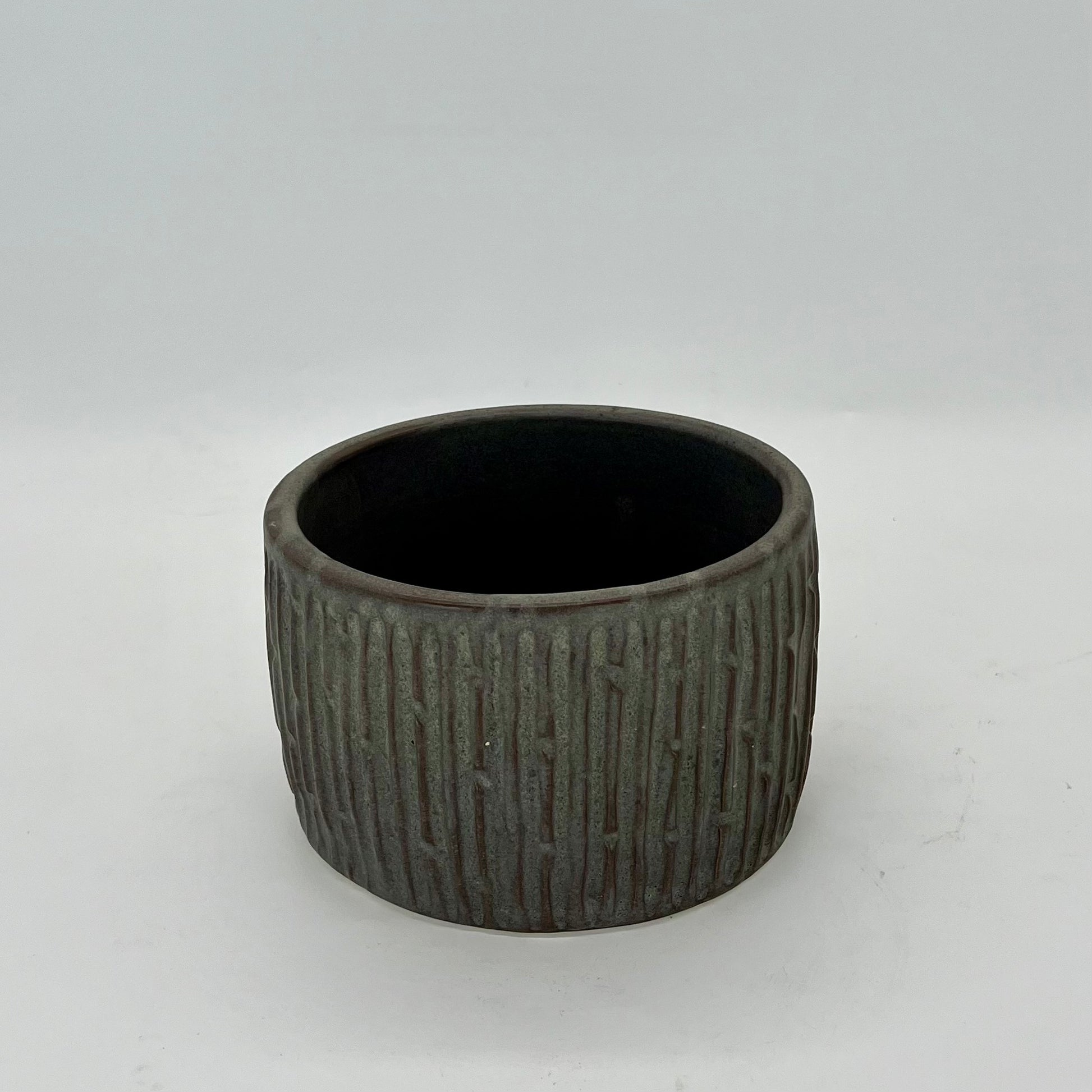 Charcoal oval-shaped, carved planter, ideal for growing herbs for the kitchen.