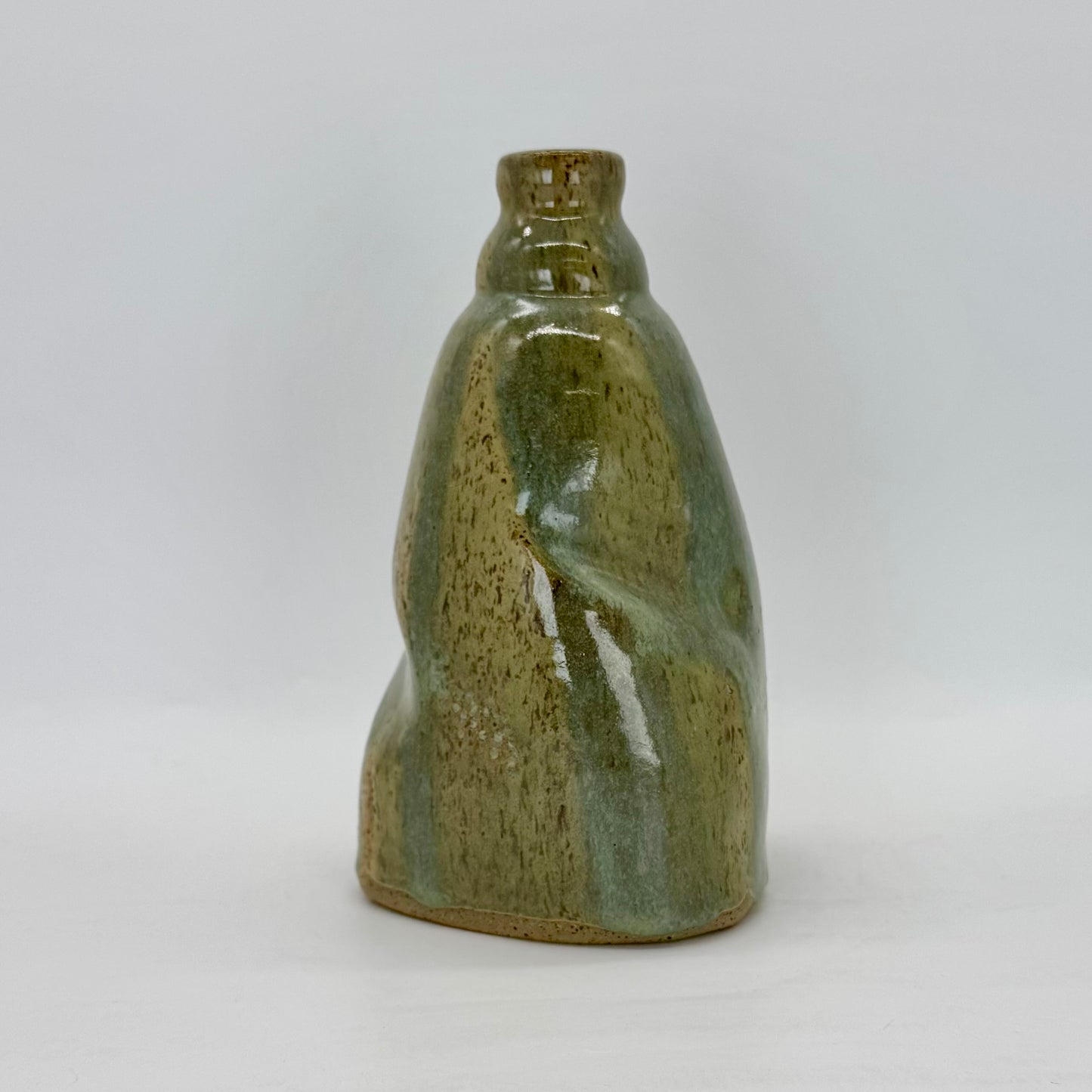 Tall Bottle Vase thrown on the wheel, manipulated in shape, distorted and poured with radiant sea mist glaze