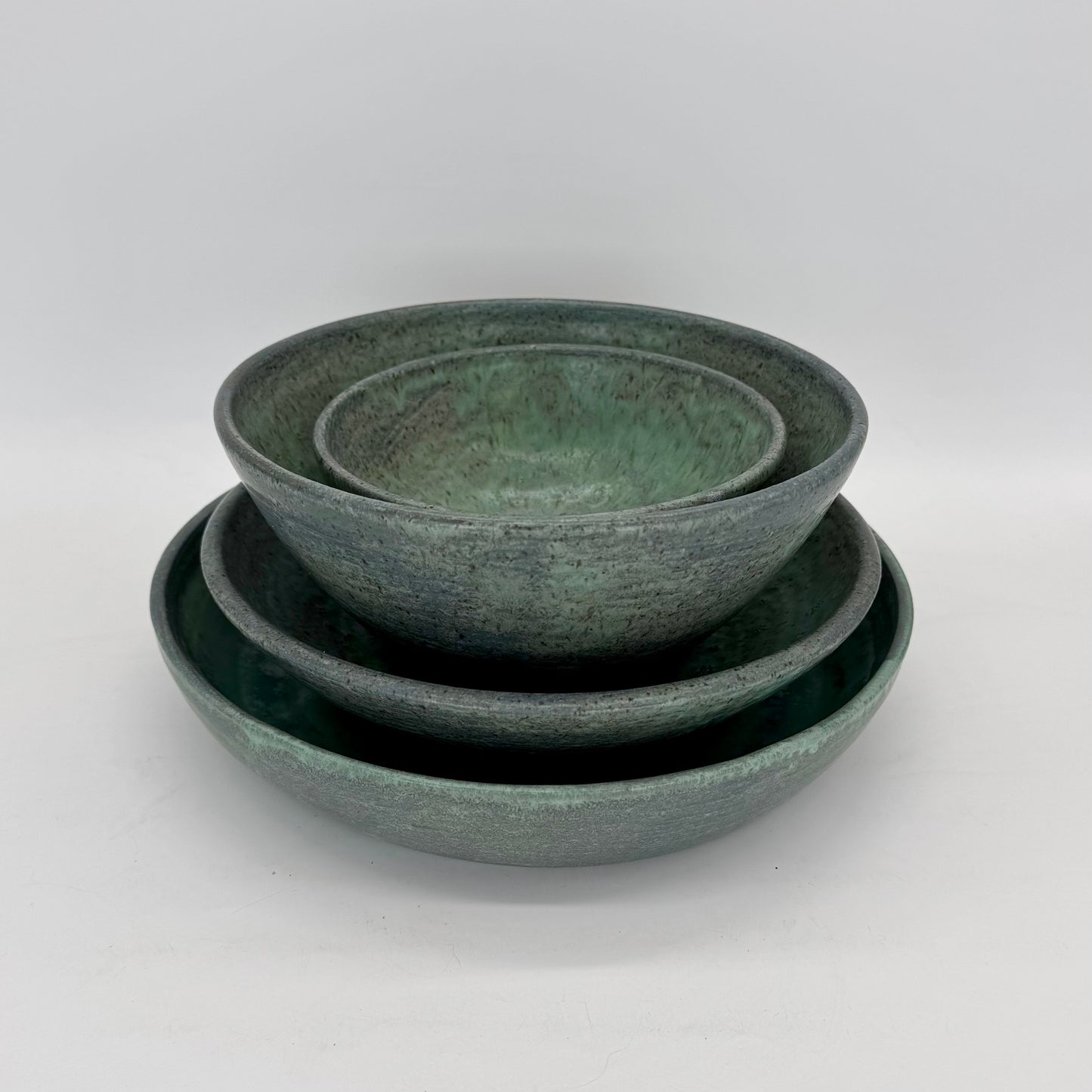 Set of bowls of varying sizes finished in matte stony blue glaze