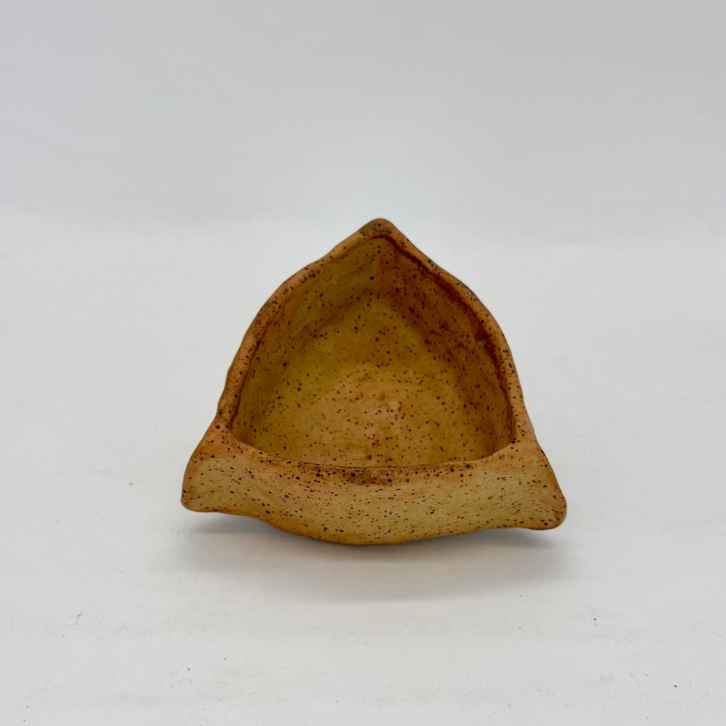 Small Pinch Pot Catch All Bowl for keys, jewelry, or even meal prep. Triangle-shaped pinch pot with exaggerated corners. Finished in a matte speckled farm egg glaze