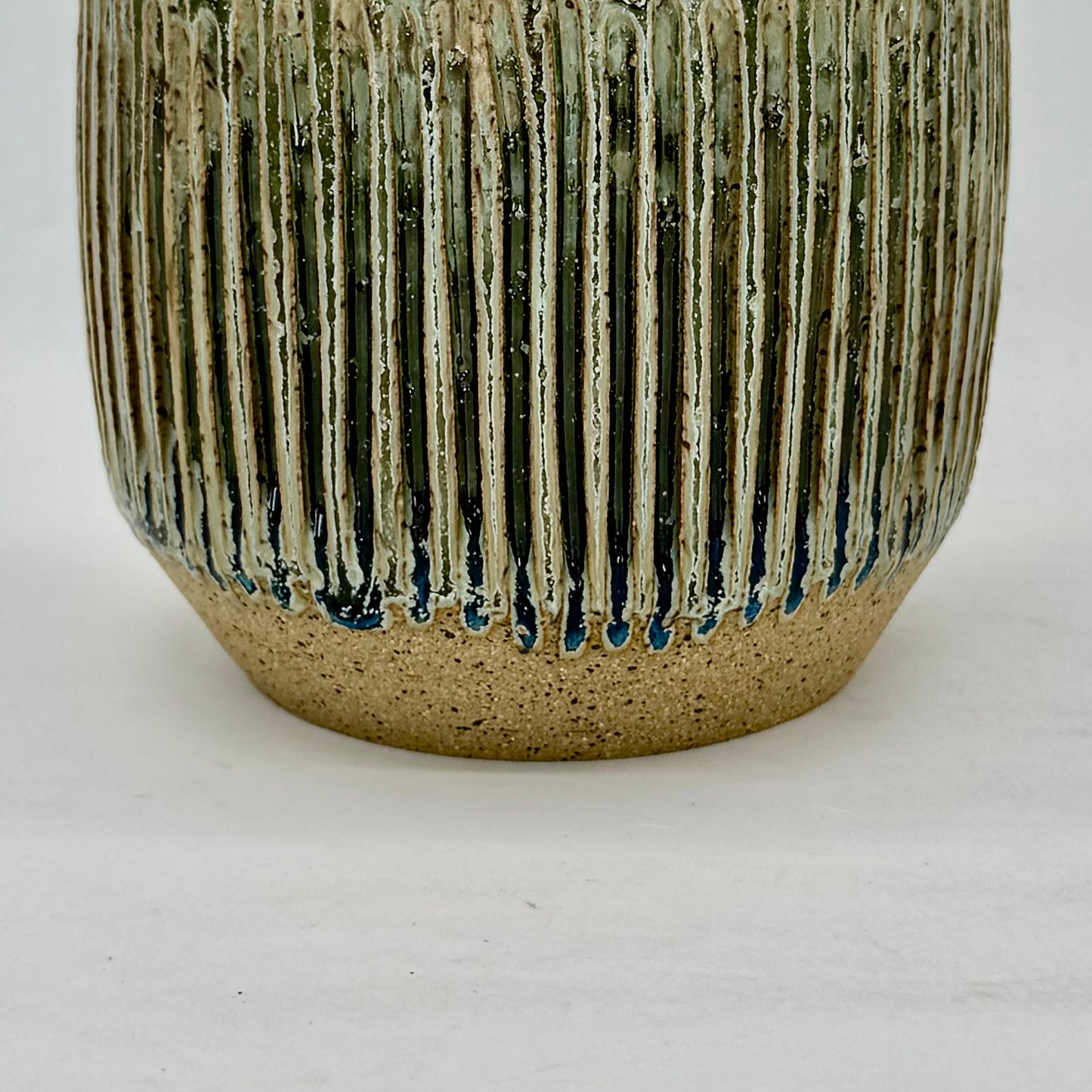 Close-up of a textured ceramic vase on a white background