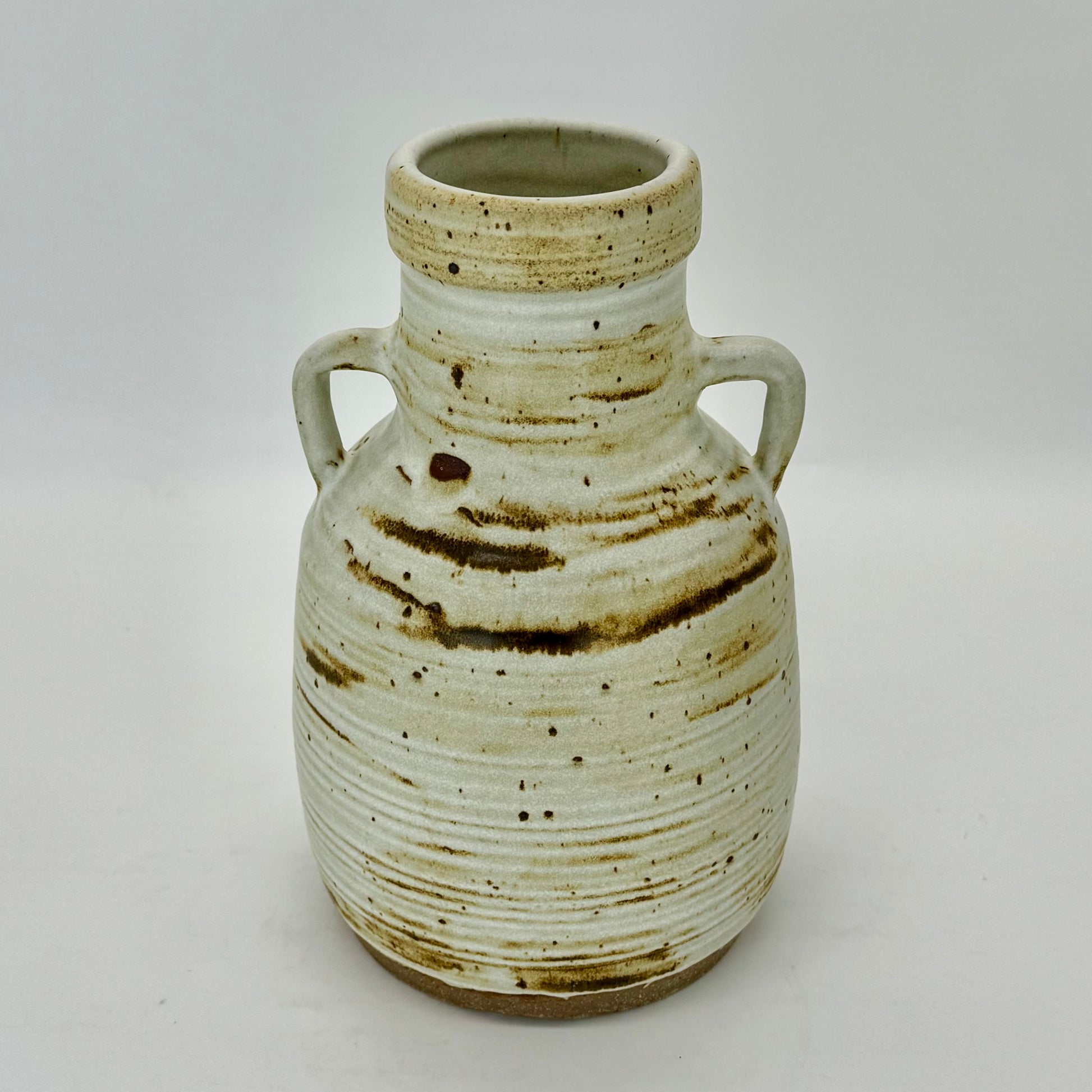 Large jug with handles, textured with subtle rings, featuring iron oxides under speckled cream matte finish.