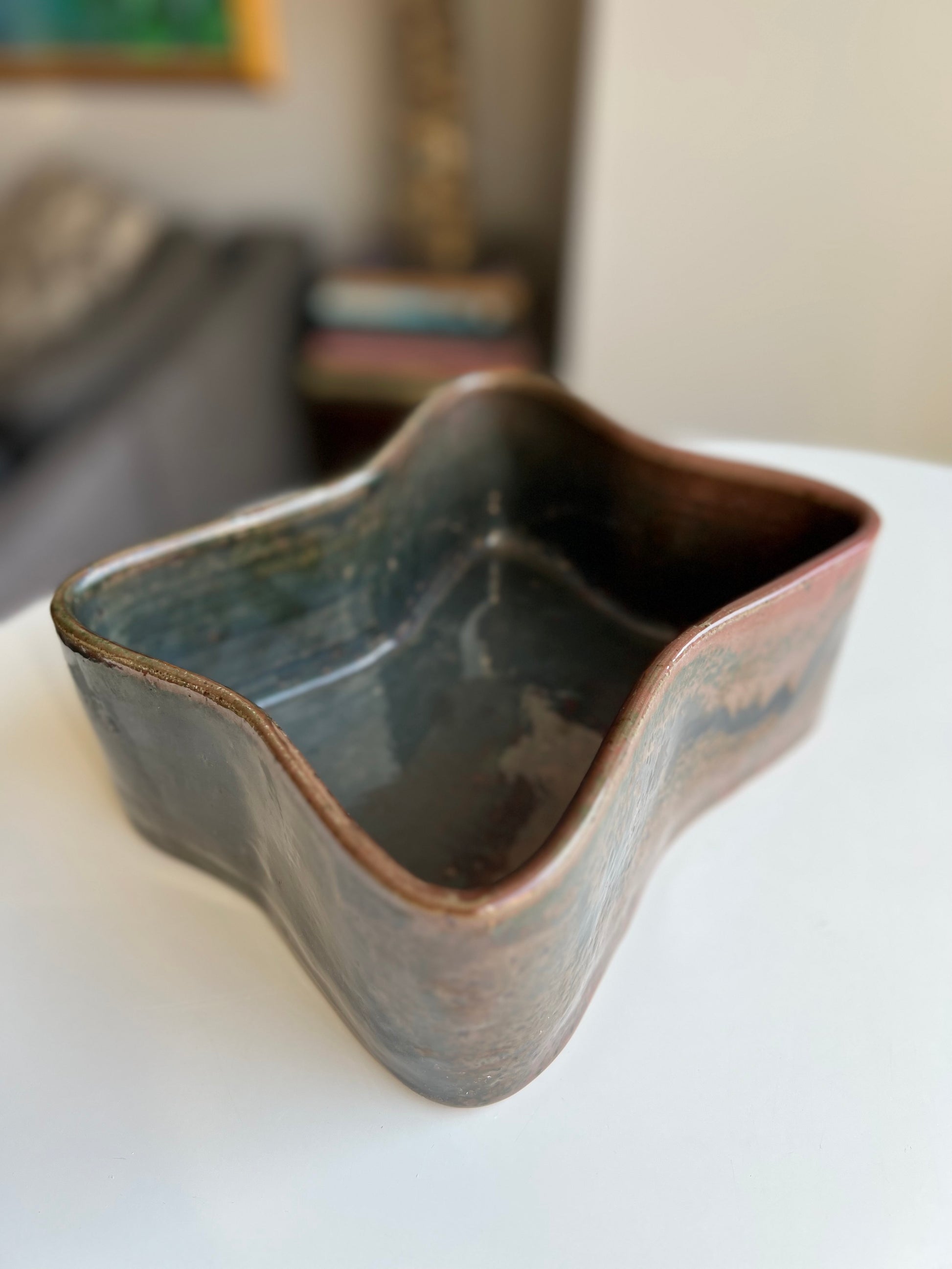 Butterfly-shaped planter. Finished in orbit glaze that is iridescent with coppers, browns, and blues.
