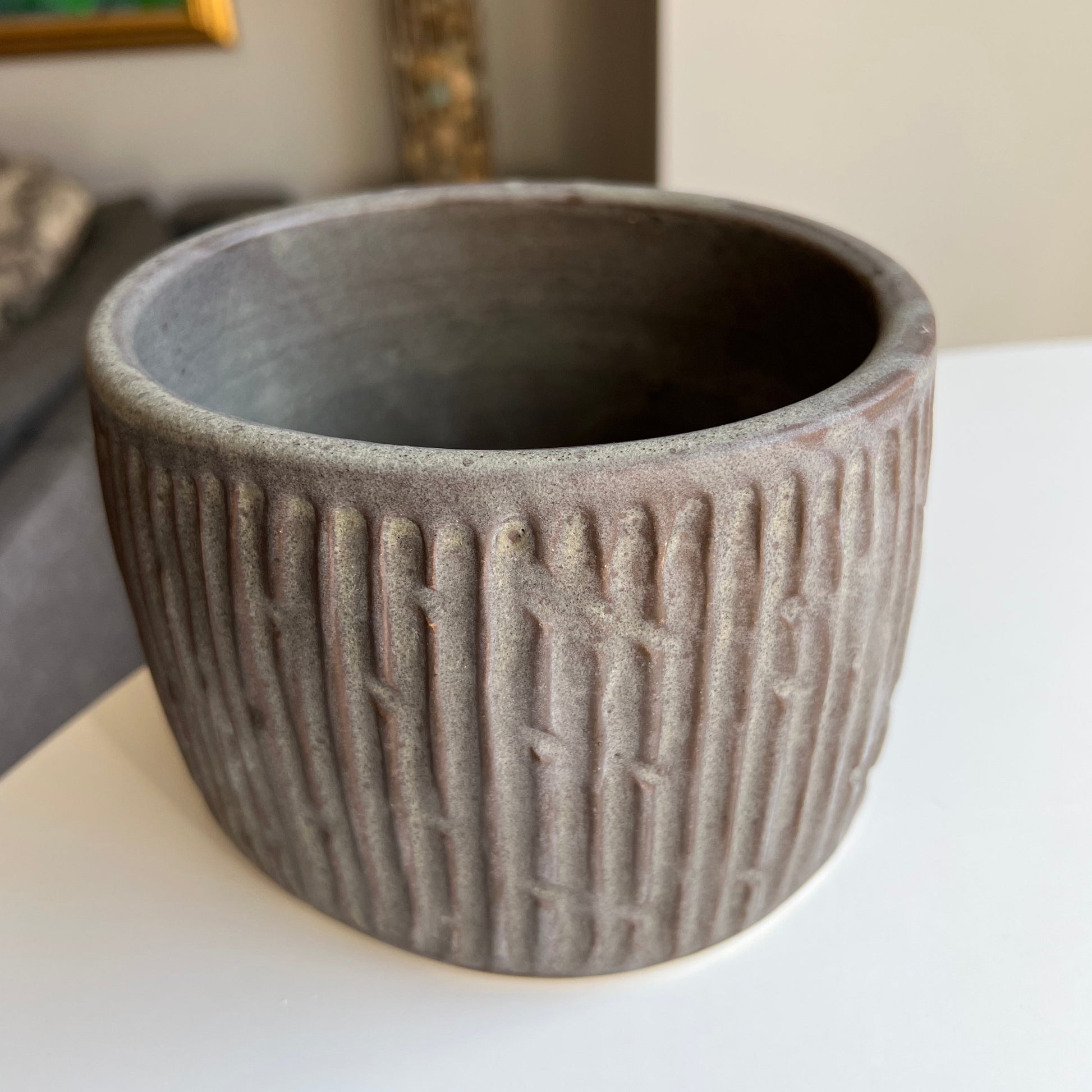 Charcoal oval-shaped, carved planter, ideal for growing herbs for the kitchen.