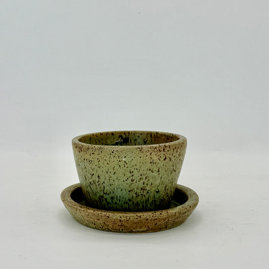 Small hand-crafted flower pot and plate in pale seaweed green inspired by Long Island Sound in New York. Ceramic planter features drainage hole and plate.