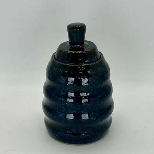 Honeycomb-shaped jar with lid. Deep midnight blue glaze. Ideal for pet treats or cookies.