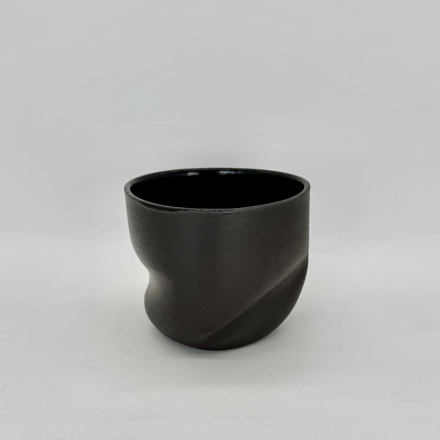 Dark and distorted vase. Part of a set of Terra Sigillata (terra sig), an old Roman technique of applying a clay and water slip before firing, giving the final firing a deep, dark matte finish