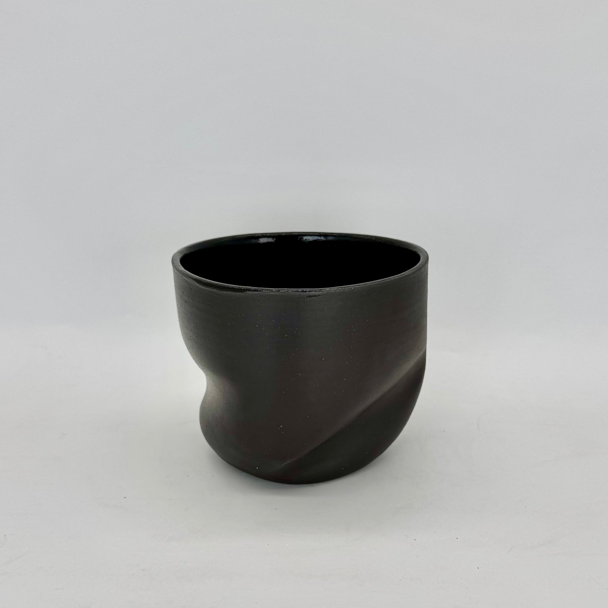 Dark and distorted vase. Part of a set of Terra Sigillata (terra sig), an old Roman technique of applying a clay and water slip before firing, giving the final firing a deep, dark matte finish