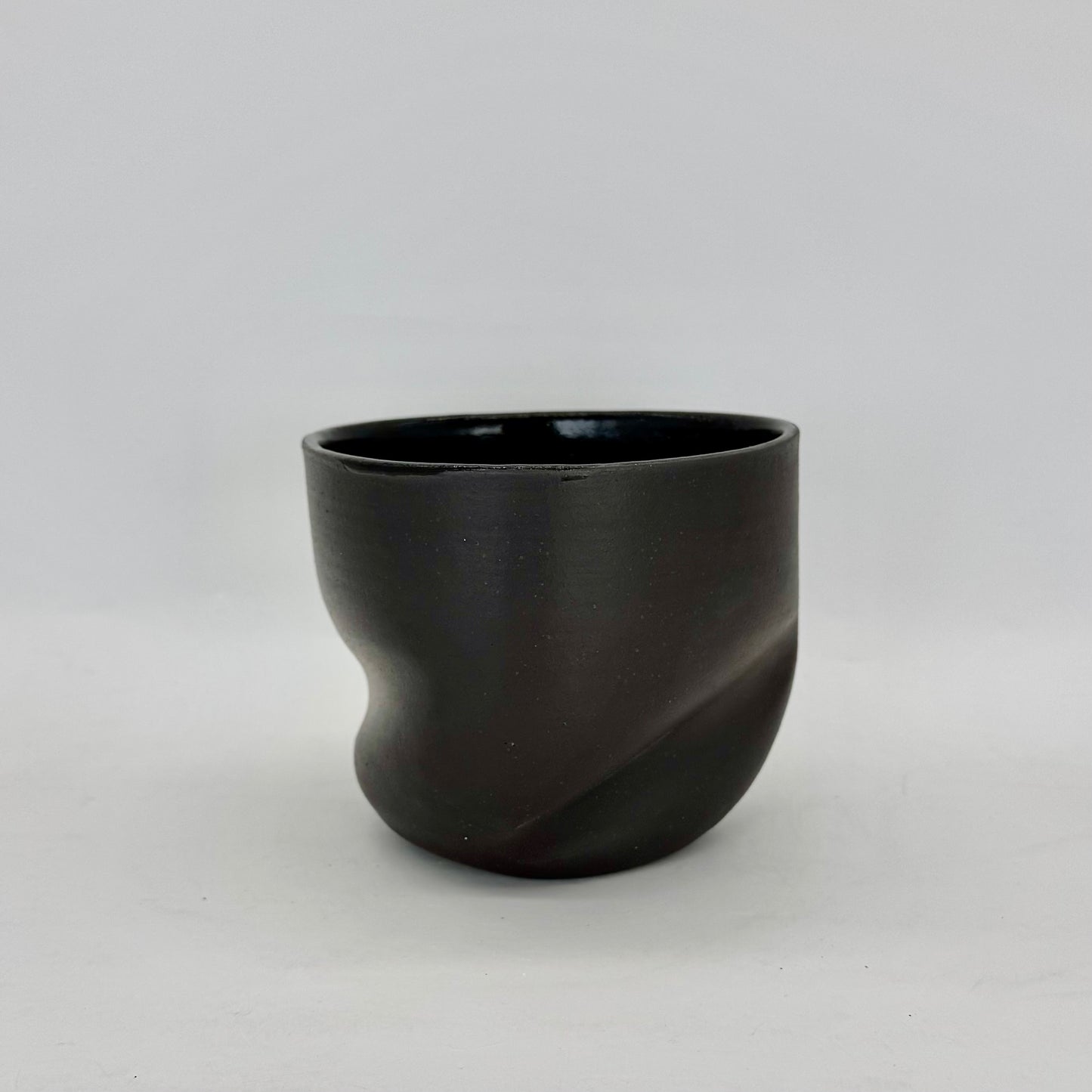 Dark and distorted vase. Part of a set of Terra Sigillata (terra sig), an old Roman technique of applying a clay and water slip before firing, giving the final firing a deep, dark matte finish
