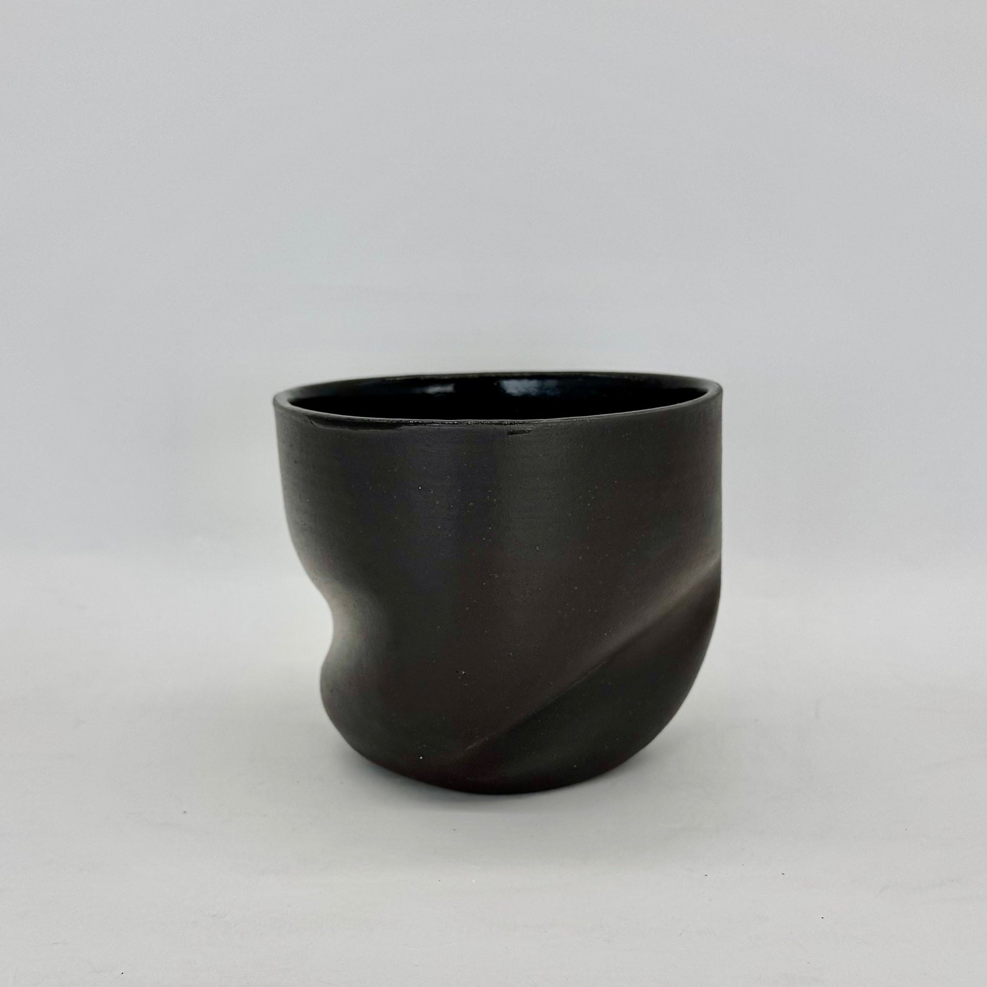 Dark and distorted vase. Part of a set of Terra Sigillata (terra sig), an old Roman technique of applying a clay and water slip before firing, giving the final firing a deep, dark matte finish